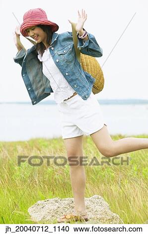 Teenage girl standing holding a basket View Large Photo Image Stock Image - Teenage girl standing holding a basket. Fotosearch