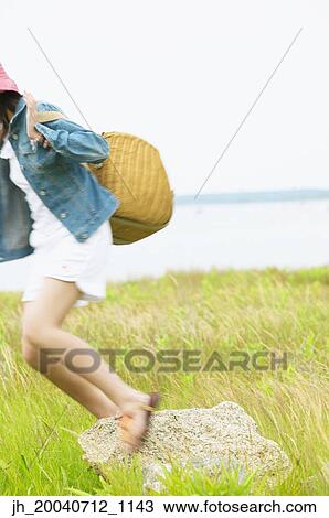 Teenage girl standing jumping holding a basket View Large Photo Image Stock Image - Teenage girl standing jumping holding a basket. Fotosearch