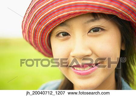 Teenage girl wearing a hat smiling View Large Photo Image Stock Photo - Teenage girl wearing a hat smiling. Fotosearch