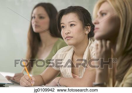 Teenage girls sitting in a classroom View Large Photo Image Stock Image - Teenage girls sitting in a classroom. Fotosearch