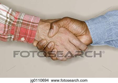 Picture - Two men shaking hands. Fotosearch
