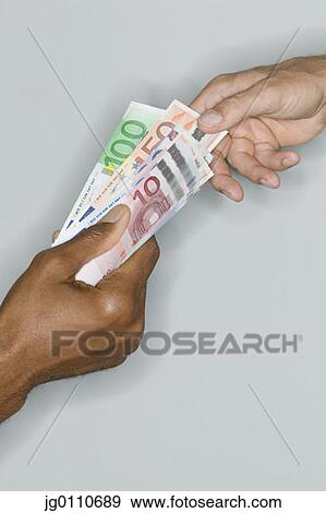 Two people exchanging bank notes View Large Photo Image Stock Photo - Two people exchanging bank notes. Fotosearch