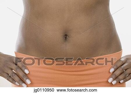 Stock Image - View of a woman's midriff. Fotosearch