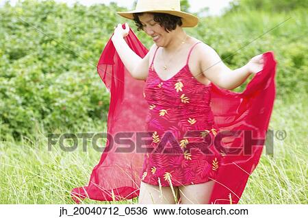 Woman at in a bathing suit and a beach hat View Large Photo Image Stock Photograph - Woman at in a bathing suit and a beach hat. Fotosearch