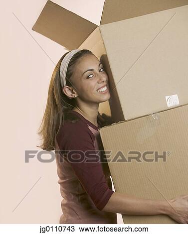 Woman carrying cardboard boxes View Large Photo Image Stock Image - Woman carrying cardboard boxes. Fotosearch