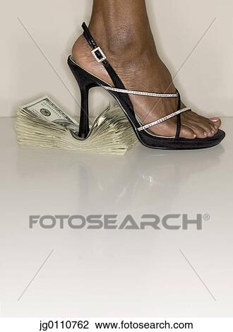 Woman foot in high heels standing on a stack of bank notes View Large Photo Image Stock Image - Woman foot in high heels standing on a stack of bank notes. Fotosearch