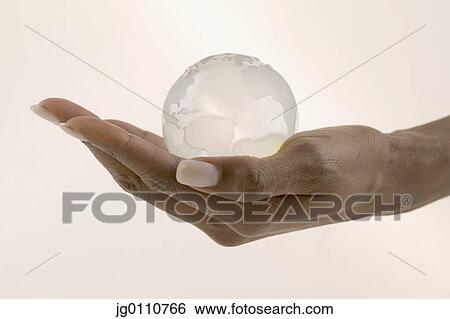 Woman's hand holding a glass globe in the palm of her View Large Photo Image Stock Photograph - Woman's hand holding a glass globe in the palm of her. Fotosearch