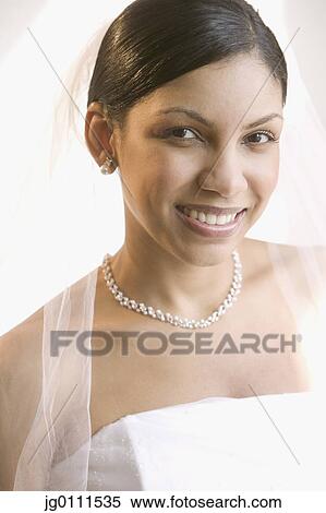 Stock Photography - Young bride looking at camera smiling. Fotosearch