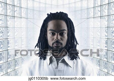 Stock Image - Young man looking at camera. Fotosearch