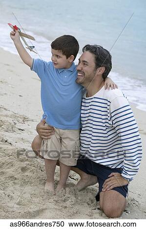 Young man with a young boy on the beach View Large Photo Image Stock Image - Young man with a young boy on the beach. Fotosearch