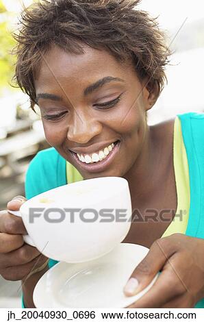 Stock Photograph - Young woman drinking coffee. Fotosearch