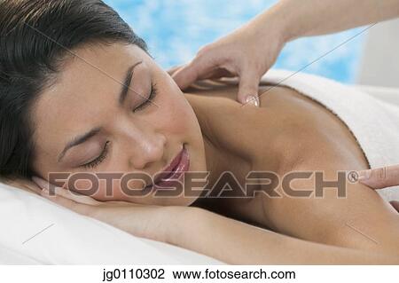 Young woman getting a back massage View Large Photo Image Stock Image - Young woman getting a back massage. Fotosearch