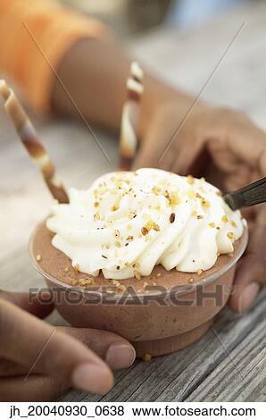 Young woman holding an ice cream View Large Photo Image Stock Photo - Young woman holding an ice cream. Fotosearch
