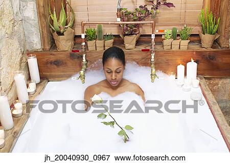 Young woman in a bubble bath View Large Photo Image Stock Photo - Young woman in a bubble bath. Fotosearch