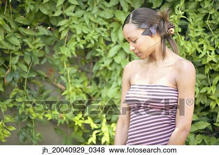 Young woman looking down View Large Photo Image Stock Photo - Young woman looking down. Fotosearch