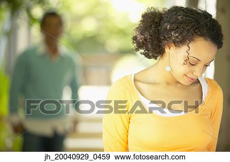 Young woman looking down View Large Photo Image Stock Photo - Young woman looking down. Fotosearch