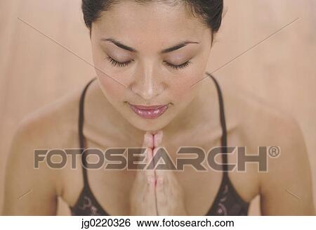 Young woman meditation with her eyes closed View Large Photo Image Stock Photograph - Young woman meditation with her eyes closed. Fotosearch