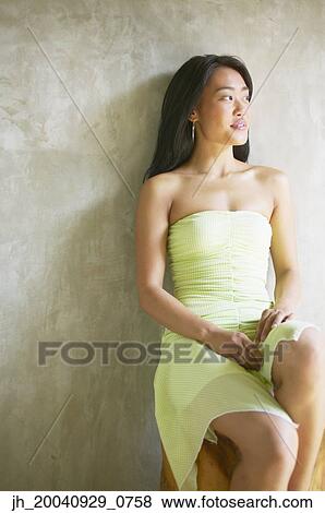 Young woman sitting looking ahead View Large Photo Image Stock Photo - Young woman sitting looking ahead. Fotosearch