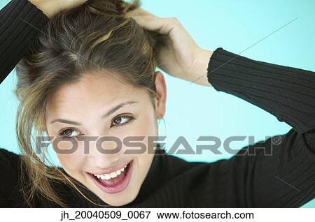 Young woman smiling looking at the side View Large Photo Image Stock Photo - Young woman smiling looking at the side. Fotosearch