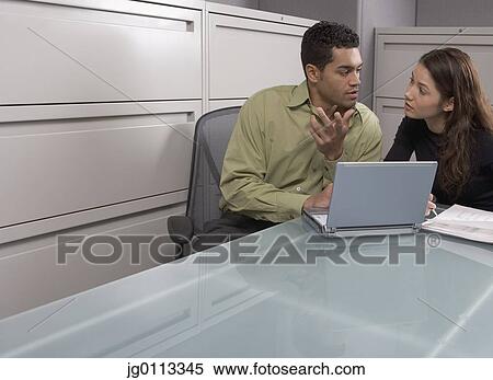 Stock Photography - Businessman talking to a businesswoman. Fotosearch
