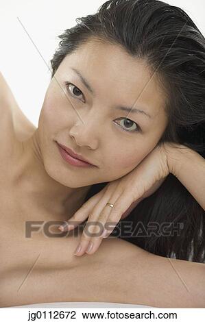 Stock Image - Close-up of a mid adult woman smiling. Fotosearch