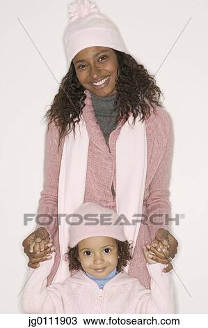 Stock Image - Close-up of a mother with her daughter smiling. Fotosearch