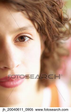 Stock Photography - Close-up of a young woman looking at camera. Fotosearch