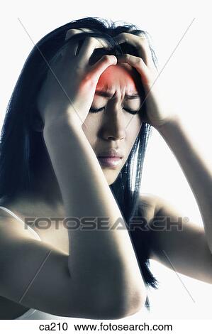 Close-up of a young woman suffering from a headache View Large Photo Image Stock Image - Close-up of a young woman suffering from a headache. Fotosearch