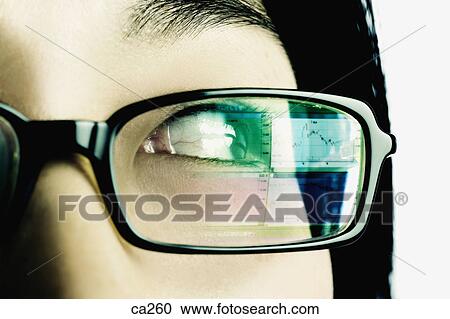 Stock Image - Extreme close-up of a young woman wearing eyeglasses. Fotosearch