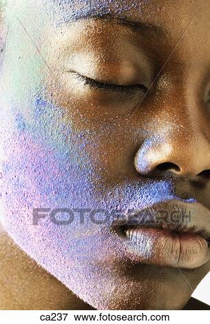 Extreme close-up of a young woman with her face painted View Large Photo Image Stock Photo - Extreme close-up of a young woman with her face painted. Fotosearch