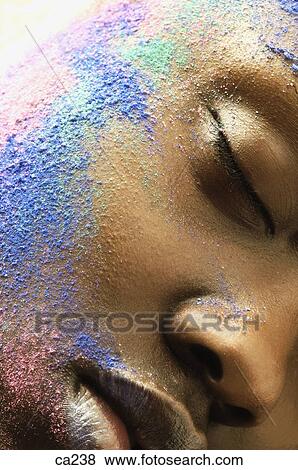 Stock Photo - Extreme close-up of a young woman with her face painted. Fotosearch