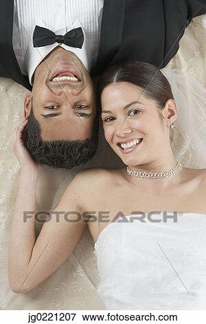 High angle view of a young newly wedded couple smiling View Large Photo Image Stock Photo - High angle view of a young newly wedded couple smiling. Fotosearch