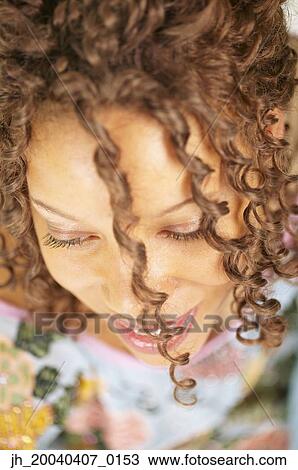 High angle view of a young woman smiling View Large Photo Image Stock Image - High angle view of a young woman smiling. Fotosearch