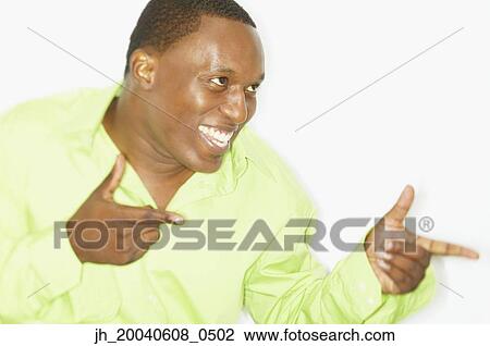 Stock Image - Mid adult man smiling looking sideways. Fotosearch