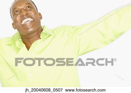 Mid adult man smiling looking up View Large Photo Image Stock Photo - Mid adult man smiling looking up. Fotosearch