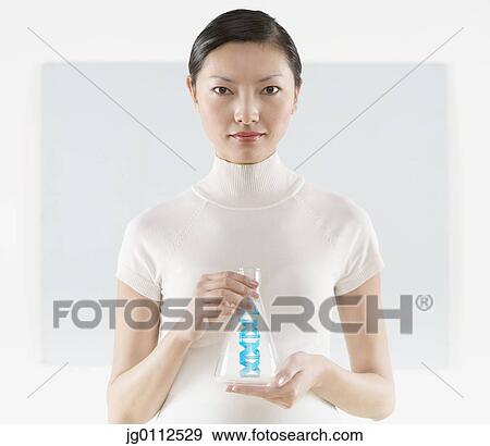 Stock Photo - Mid adult woman holding a bottle. Fotosearch