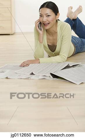 Mid adult woman talking on a mobile phone View Large Photo Image Stock Image - Mid adult woman talking on a mobile phone. Fotosearch