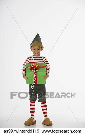 Portrait of a boy holding a gift View Large Photo Image Stock Photo - Portrait of a boy holding a gift. Fotosearch
