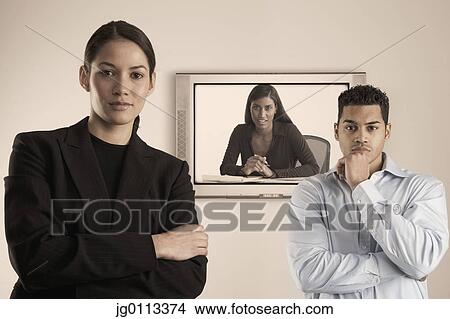 Portrait of a businessman and a businesswoman in a teleconference View Large Photo Image Picture - Portrait of a businessman and a businesswoman in a teleconference. Fotosearch
