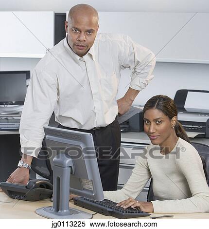 Stock Photography - Portrait of a businessman and a businesswoman. Fotosearch
