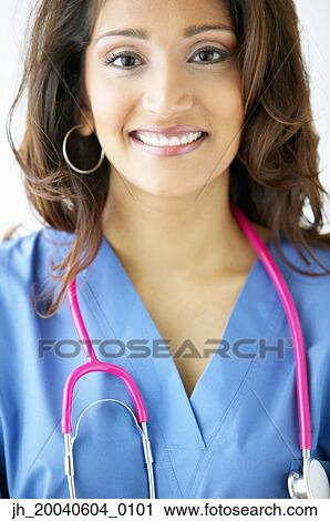 Portrait of a female doctor standing with a stethoscope around her neck View Large Photo Image Stock Image - Portrait of a female doctor standing with a stethoscope around her neck. Fotosearch