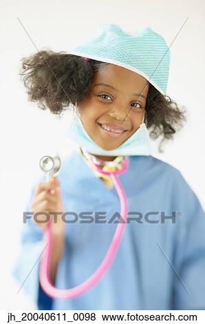 Portrait of a girl wearing medical scrubs holding a stethoscope View Large Photo Image Stock Photo - Portrait of a girl wearing medical scrubs holding a stethoscope. Fotosearch