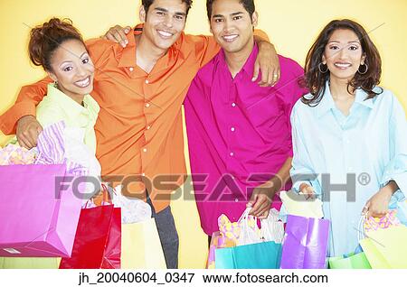 Portrait of a group of young people holding shopping bags View Large Photo Image Stock Photo - Portrait of a group of young people holding shopping bags. Fotosearch