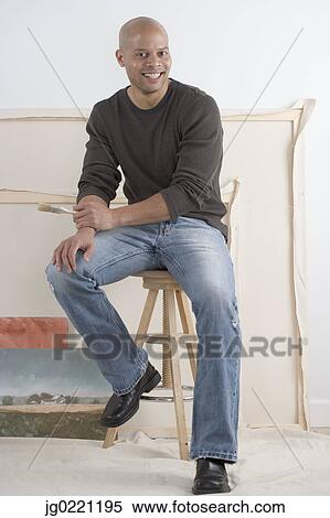Portrait of a male artist holding a brush smiling View Large Photo Image Stock Photography - Portrait of a male artist holding a brush smiling. Fotosearch