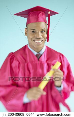 Portrait of a male graduate holding a degree View Large Photo Image Picture - Portrait of a male graduate holding a degree. Fotosearch