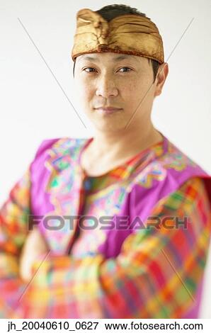 Portrait of a mid adult man wearing a traditional outfit View Large Photo Image Stock Photo - Portrait of a mid adult man wearing a traditional outfit. Fotosearch