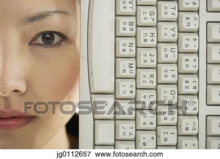 Stock Photo - Portrait of a mid adult woman with a computer keyboard. Fotosearch