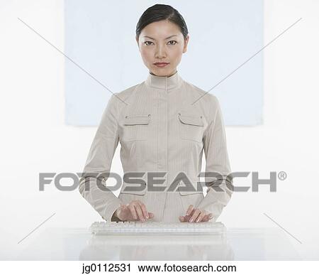 Portrait of a mid adult woman working on a computer keyboard View Large Photo Image Stock Image - Portrait of a mid adult woman working on a computer keyboard. Fotosearch
