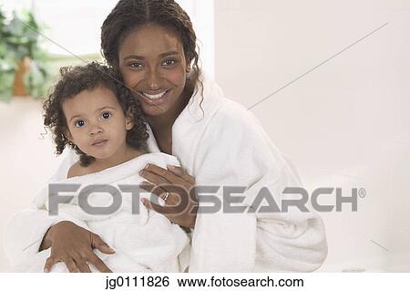 Portrait of a mother with her daughter smiling View Large Photo Image Stock Photograph - Portrait of a mother with her daughter smiling. Fotosearch