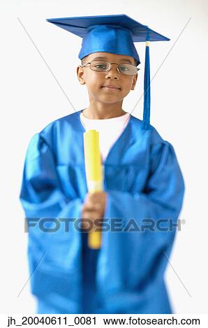 Portrait of a young boy wearing a graduation gown holding a diploma View Large Photo Image Stock Image - Portrait of a young boy wearing a graduation gown holding a diploma. Fotosearch